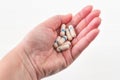 Burgas, Bulgaria Ã¢â¬â February 03, 2019: Female hand holding many colorful pills, capsules, tablets on white wooden background.